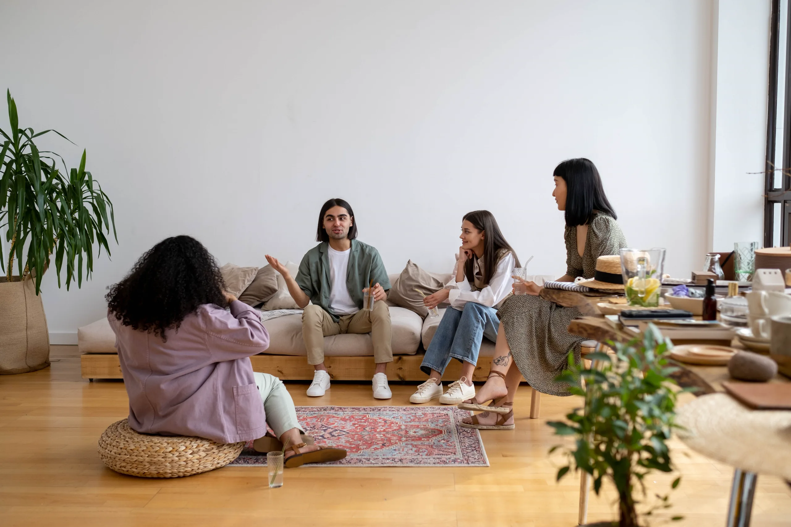 A diverse group of friends in conversation in a modern living room
